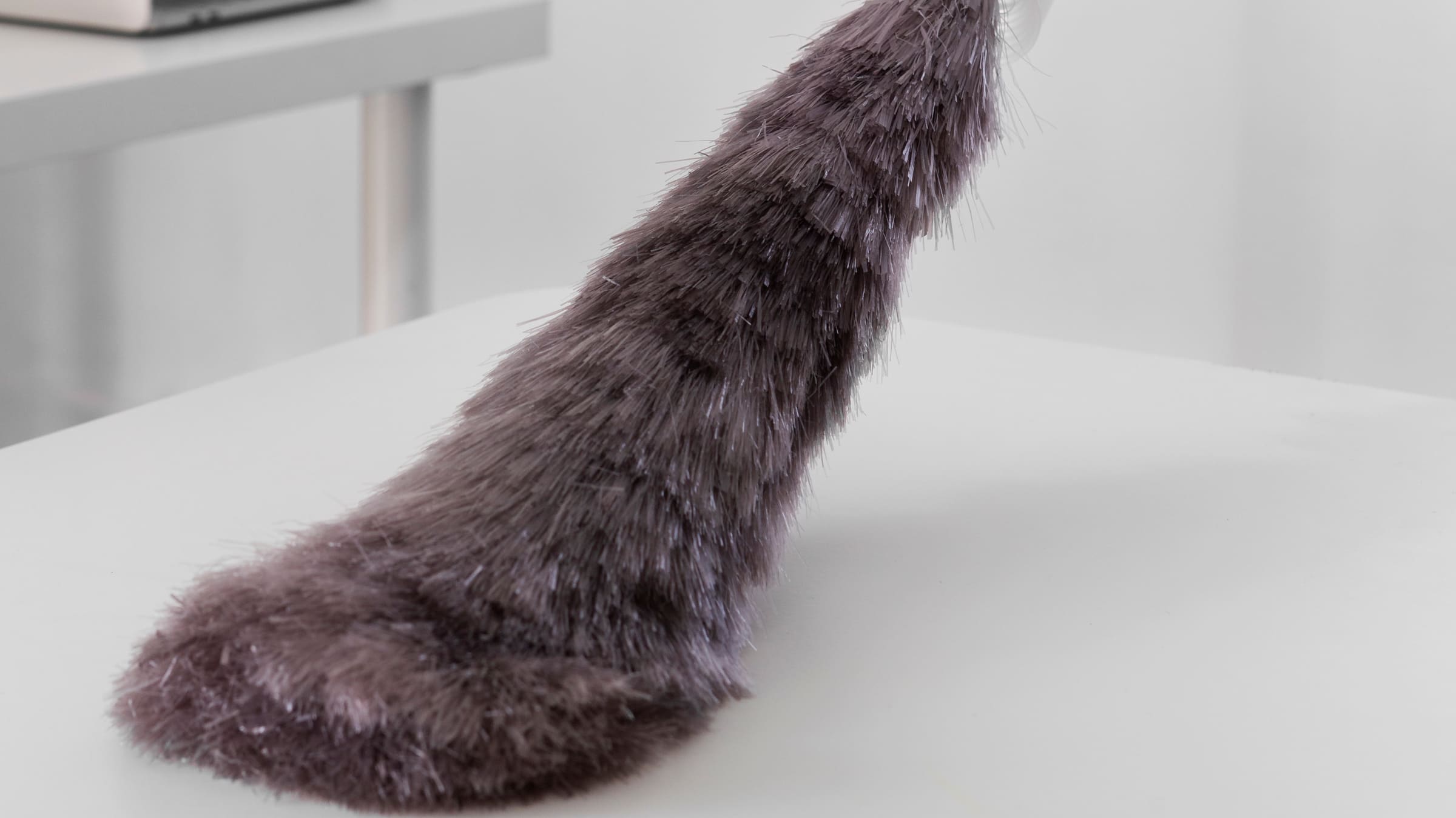 A duster drawn across a white desk